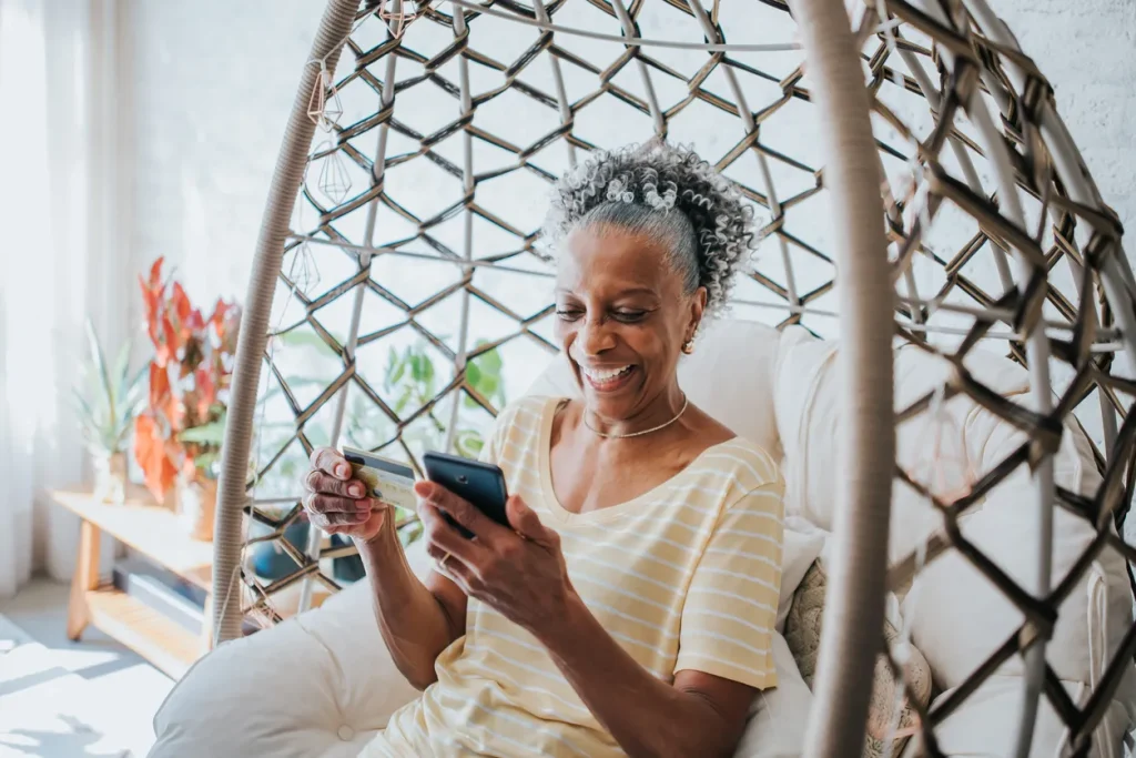 Thank you for your order. Older woman making an online purchase with a credit card, confirming her order received on the recipe page.