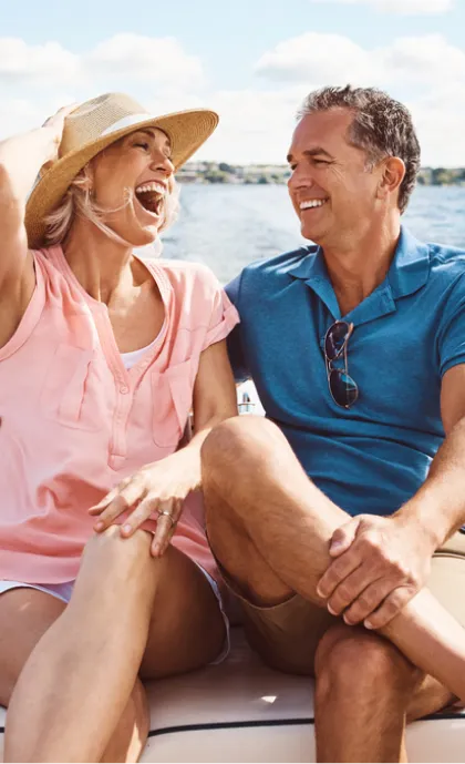 A happy couple sitting on a beach.