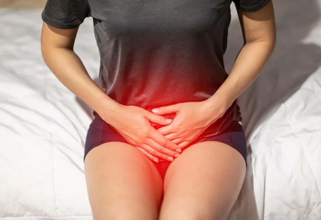 A woman experiencing discomfort is cradling her bladder, highlighting the struggle with Interstitial Cystitis/Bladder Pain.